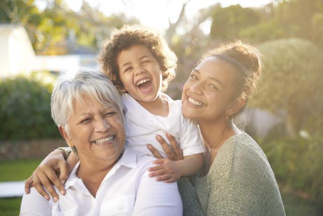An older woman with her adult daughter and young granddaughter